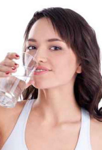 woman drinking a glass of water